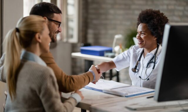 couple meeting their General Practitioner